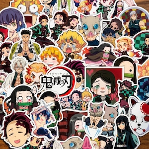 May include: A selection of colourful anime character stickers. The stickers depict various characters with detailed facial expressions and vibrant clothing. Some stickers have Japanese text. The stickers are arranged on a wooden surface.