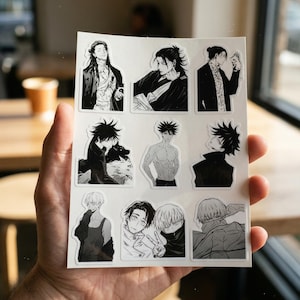 May include: A white sticker sheet featuring nine distinct black and white anime-style illustrations of various characters. The designs include portraits and figures in different poses, showcasing detailed line work and shading typical of manga art styles.