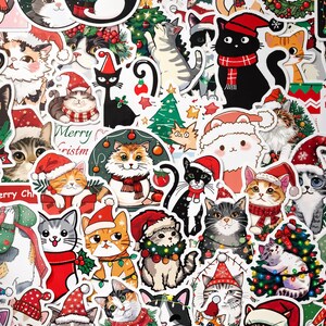 May include: A collection of stickers featuring various cats in Christmas-themed attire and settings. The illustrations include cats wearing Santa hats, scarves, and wreaths, alongside Christmas trees, ornaments, and the text Merry Christmas.
