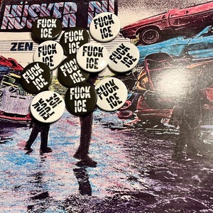 May include: A collection of circular pin-back buttons featuring the text FUCK ICE in bold black or white lettering. The buttons are arranged in a cluster, with some having black backgrounds with white text and others having white backgrounds with black text.