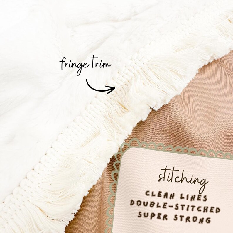 May include: Close-up of a white blanket with a fringe trim. The blanket has a soft, textured surface. The text on the image says "stitching: clean lines, double-stitched, super strong."