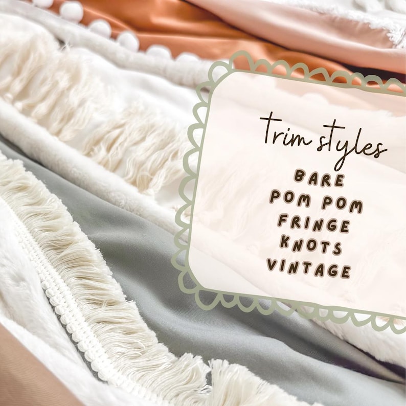 May include: Close-up of various fabric trim styles, including bare, pom pom, fringe, knots, and vintage. The fabrics are in neutral colors like white, cream, and light blue, with a peach-colored accent. The image features the text "Trim Styles".