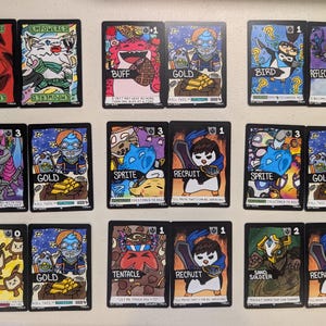 May include: A collection of seventeen rectangular trading cards arranged in three rows. Each card features colourful, hand-drawn illustrations of various characters and items, with bold black borders, text labels, and numerical values in the corners.