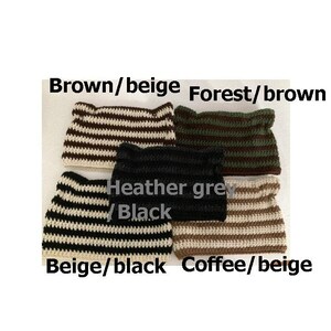 May include: Four crocheted striped headbands in different color combinations: brown and beige, forest green and brown, heather grey and black, and beige and black. The headbands are stacked on top of each other.