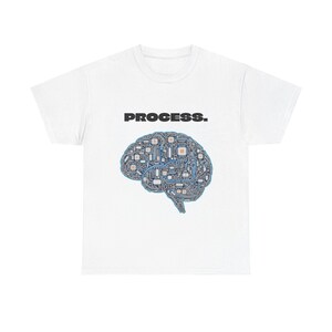 May include: White t-shirt featuring the word "PROCESS." above a stylized brain graphic. The brain design is composed of circuit board elements in shades of blue, gray, and brown, creating a tech-inspired aesthetic.