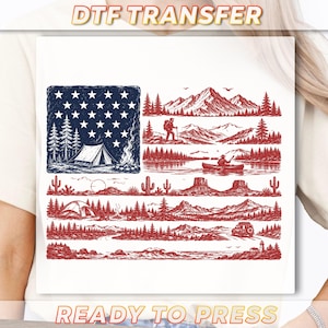 May include: A DTF transfer featuring a graphic design of the American flag composed of outdoor scenes. The blue canton contains white stars, a tent, and a campfire. The red stripes depict mountains, forests, a person canoeing, cacti, and a vehicle.