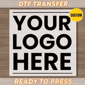 May include: A white square with the words "YOUR LOGO HERE" in large black letters. The words "DTF TRANSFER" and "READY TO PRESS" are in orange text at the top and bottom. A yellow "CUSTOM" sticker is in the upper right corner.