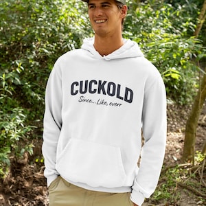 May include: White hoodie with the word "CUCKOLD" in navy blue block letters, with the phrase "Since...Like, everr" underneath. The hoodie has a front pocket and a drawstring hood.