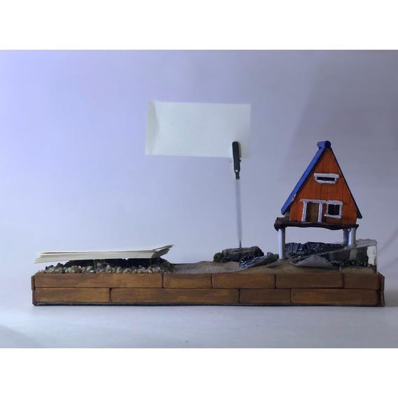 A handmade wood + epoxy + polymer clay mashup shaped like a nautical dock — it's part sculpture, part desk organizer, and entirely one-of-a-kind.