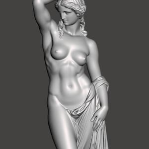 May include: A grayscale sculpture of a nude female figure with her arm raised above her head. She is draped in a cloth around her lower body and over her left arm. The statue has detailed facial features and flowing hair.