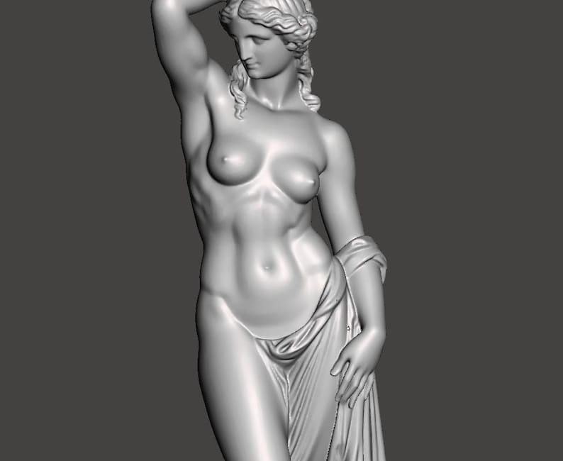 May include: A grayscale sculpture of a nude female figure with her arm raised above her head. She is draped in a cloth around her lower body and over her left arm. The statue has detailed facial features and flowing hair.
