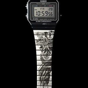 May include: A silver-tone digital wristwatch with a black rectangular face featuring the Casio logo, alarm, and chronograph text. The metal link band is engraved with a detailed black dragon illustration that extends across the watch links.