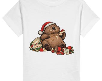 May include: A white t-shirt featuring a graphic of a brown wombat wearing a red and white Santa hat. The wombat is eating food, surrounded by scattered berries and a small card that reads Merry Christmas Anyway with a tiny red heart.