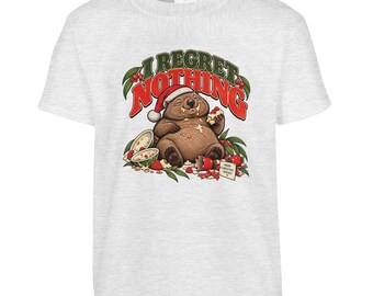 May include: A light grey short-sleeved t-shirt featuring a graphic of a brown wombat wearing a red Santa hat, eating food with crumbs on its chest. Above the wombat, the text reads I REGRET NOTHING in red and green letters.