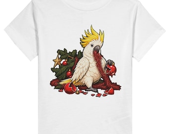 May include: A white t-shirt featuring a graphic of a white cockatoo with a yellow crest. The bird is surrounded by green pine branches, a gold star, and red Christmas baubles, some of which are broken into pieces on the ground.