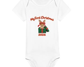May include: A white short-sleeved baby bodysuit featuring a graphic of a kangaroo inside a green gift box with a red bow. Above the kangaroo, the text reads My First Christmas in red, and below the box, the year 2026 is printed in red.