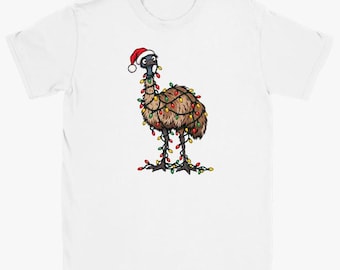 May include: A white short-sleeved t-shirt featuring a graphic of a brown emu wearing a red and white Santa hat. The emu is wrapped in a string of colourful Christmas lights in red, green, and yellow, which drape down to its feet.