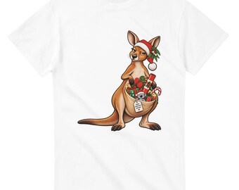 May include: A white t-shirt featuring a graphic of a brown kangaroo wearing a red and white Santa hat. The kangaroo has a pouch filled with wrapped Christmas gifts, a candy cane, and a small koala, with a tag reading Merry Christmas Mate.