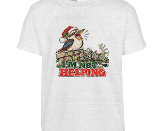 May include: A light grey short-sleeve t-shirt featuring a graphic of a kookaburra wearing a Santa hat, perched on a fence tangled in colourful Christmas lights. The text below the illustration reads I'M NOT HELPING in bold green and red letters.