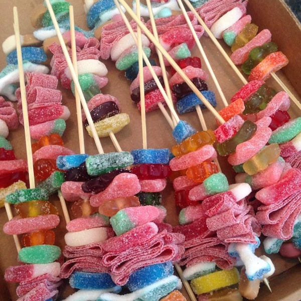 24 Candy Fruit Kabob Skewers rainbow colored with squishmallow axolotl marshmallow added on it.