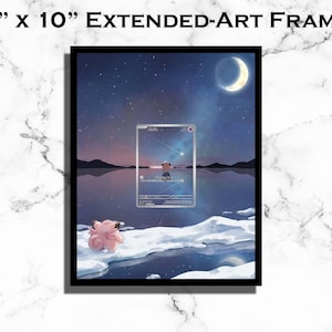May include: Black framed 8" x 10" extended art print. The artwork depicts a serene night scene with a crescent moon, starry sky, and a figure on a frozen lake. A pink creature sits on the ice. The print includes a card-like design.
