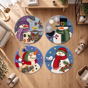 May include: Four circular rugs featuring winter themes. Each rug displays a snowman with colorful accessories like scarves and hats, accented by elements such as birds, pine branches, berries, and snowflakes against blue backgrounds.