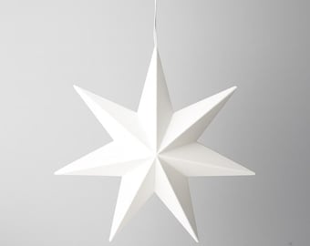 May include: A white, eight-pointed star-shaped decoration hanging from a thin white cord. The star has sharp, angular points and a clean, minimalist design, perfect for holiday or festive decor.