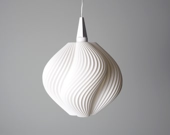 May include: A white, modern pendant light fixture. The light has a bulbous, swirling design, with a white cord and a geometric top. The light is suspended against a gray background.