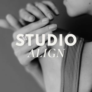 May include: Black and white image featuring the text "STUDIO ALIGN" overlaid on a person's hands and shoulder. The hands are gently touching, with one hand wearing a ring. The person is wearing a ribbed top.