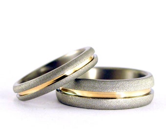 Sandblasted titanium and yellow gold 18ct wedding ring set. Sandblasted rounded titanium matching wedding bands. Golden rings (01558_4N7N)