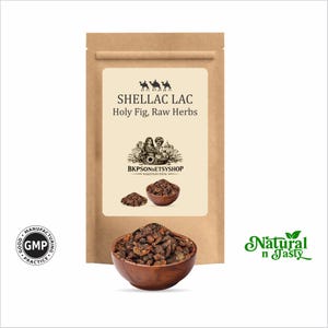 May include: A brown paper bag with a cream-colored label featuring text that reads "SHELLAC LAC Holy Fig, Raw Herbs." Below the label is a wooden bowl filled with dark brown herbs. A smaller bowl and pile of herbs are also visible.