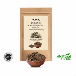 May include: A brown paper bag with a label featuring text that reads "Organic Badrani Boya" and "Billilotan, Catnip, Dried Badrani." A wooden bowl filled with dried herbs is in front of the bag. The words "Natural n Tasty" are in green.