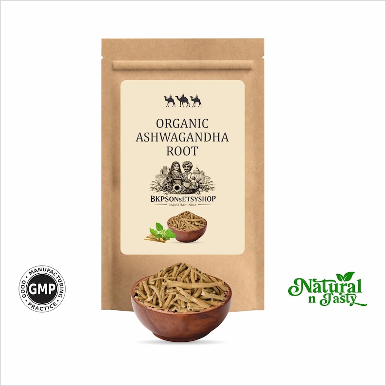 May include: A brown paper bag with a label that reads "Organic Ashwagandha Root." A wooden bowl filled with dried root pieces is in front of the bag. The text "Natural n Tasty" is in green script on the right.