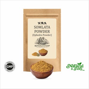 May include: A brown paper bag labelled "SOMLATA POWDER (Ephedra Powder)". A wooden bowl filled with brown powder is in front of the bag. The image also includes the text "Natural n Tasty".