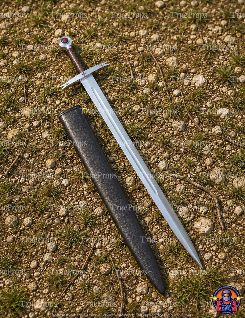 May include: A silver-toned steel sword with a brown leather-wrapped grip and a circular pommel featuring a red cross emblem. The crossguard displays small red cross symbols on each end. A black scabbard lies alongside the blade on the ground.