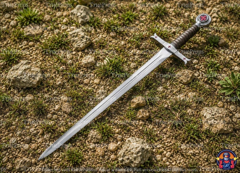 May include: A silver-toned metal sword featuring a long, pointed blade with a central fuller. The crossguard and circular pommel are adorned with small red cross emblems. The handle is wrapped in dark material for a secure grip.