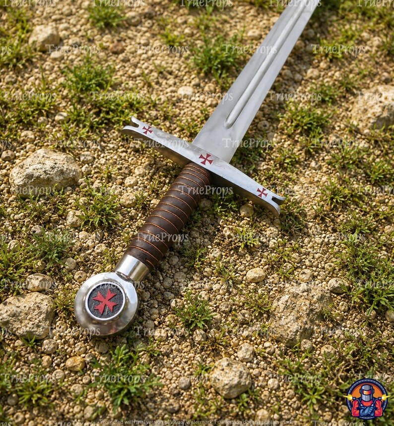 May include: A metal sword featuring a silver blade, a brown leather-wrapped grip, and a circular pommel with a red cross emblem. The crossguard is decorated with three small red crosses, and the pommel displays a prominent red Maltese cross.