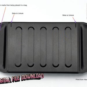 May include: A black rectangular object with curved indentations and rounded edges. The text "Slide to Unlock" is visible, along with the words "DIGITAL FILE DOWNLOAD" and "BKKK BY BLACK GEKKO".