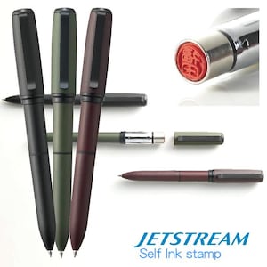 May include: A collection of Jetstream self-ink pens in black, olive green, and burgundy. The image also shows a close-up of the stamp and the pen's components. The text "JETSTREAM Self Ink stamp" is visible at the bottom.