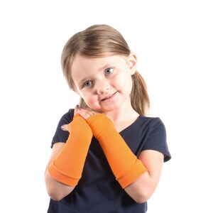 May include: A young person wearing a navy blue shirt with orange arm warmers. The arm warmers are made of a soft, stretchy fabric and are perfect for keeping warm in the cooler months.