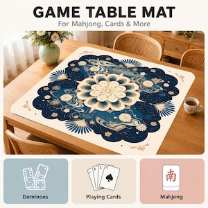 May include: A square game table mat featuring a central cream-colored floral mandala surrounded by dark blue patterns of waves, fans, and small blossoms. The mat includes text reading GAME TABLE MAT For Mahjong, Cards & More, plus icons for dominoes, playing cards, and a mahjong tile.
