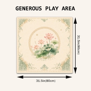 May include: A square play mat featuring a central circular frame with a Greek key pattern enclosing pink lotus flowers and green lily pads. The cream-colored mat has decorative green floral corners and measures 31.5 inches by 31.5 inches.