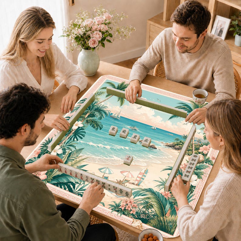 May include: A square mahjong table mat featuring a tropical beach scene with palm trees, ocean waves, and colorful umbrellas. The mat is bordered by a red geometric pattern and includes several mahjong tiles with Chinese characters placed on top.