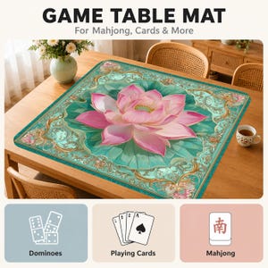 May include: A square game table mat featuring a large pink lotus flower centered on a teal background with ornate gold filigree borders. The text GAME TABLE MAT For Mahjong, Cards & More appears above, with icons for dominoes, cards, and mahjong tiles below.