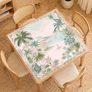 May include: A square wooden table with a tropical landscape design. The table features a pastel pink and blue background with palm trees, sailboats, and lush greenery. The table is surrounded by four wooden chairs with woven backs.