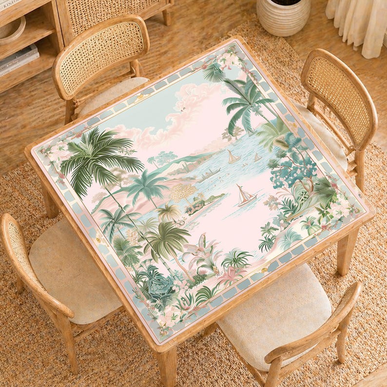 May include: A square wooden table with a tropical landscape design. The table features a pastel pink and blue background with palm trees, sailboats, and lush greenery. The table is surrounded by four wooden chairs with woven backs.