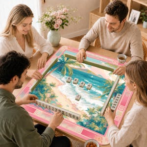 May include: A square mahjong mat featuring a tropical beach scene with palm trees, blue ocean waves, and sand. The mat has a pink border with geometric patterns. Several mahjong tiles with black Chinese characters are arranged on the surface.
