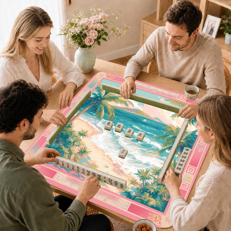 May include: A square mahjong mat featuring a tropical beach scene with palm trees, blue ocean waves, and sand. The mat has a pink border with geometric patterns. Several mahjong tiles with black Chinese characters are arranged on the surface.