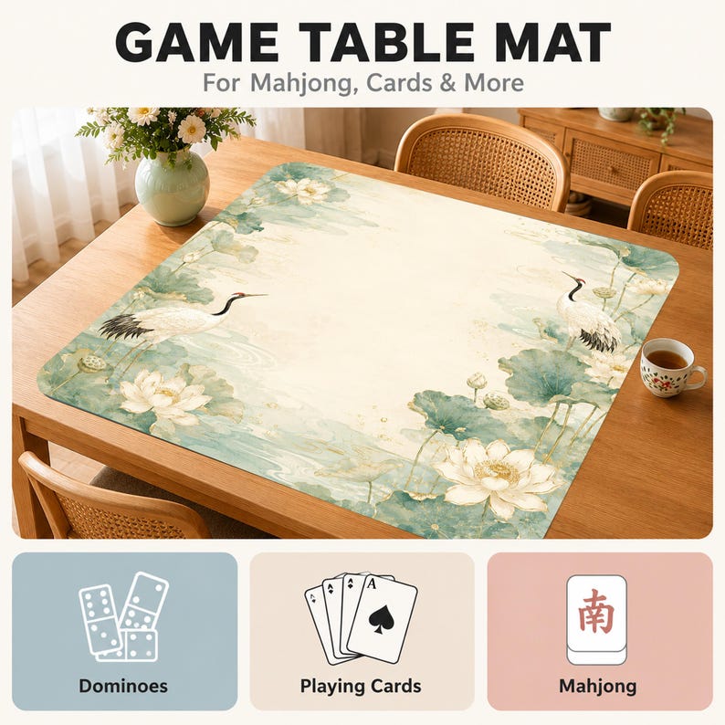 May include: A rectangular game table mat featuring a printed design of white cranes and lotus flowers in shades of green and cream. The mat is displayed on a wooden table and includes text that reads GAME TABLE MAT For Mahjong, Cards & More.
