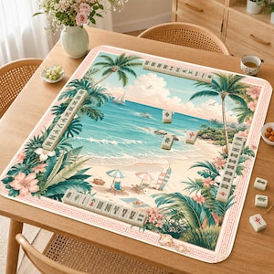 May include: A rectangular mahjong mat featuring a tropical beach scene with palm trees, ocean waves, and colorful umbrellas. The mat is bordered by a decorative pattern and includes several mahjong tiles arranged in rows and scattered on the surface.